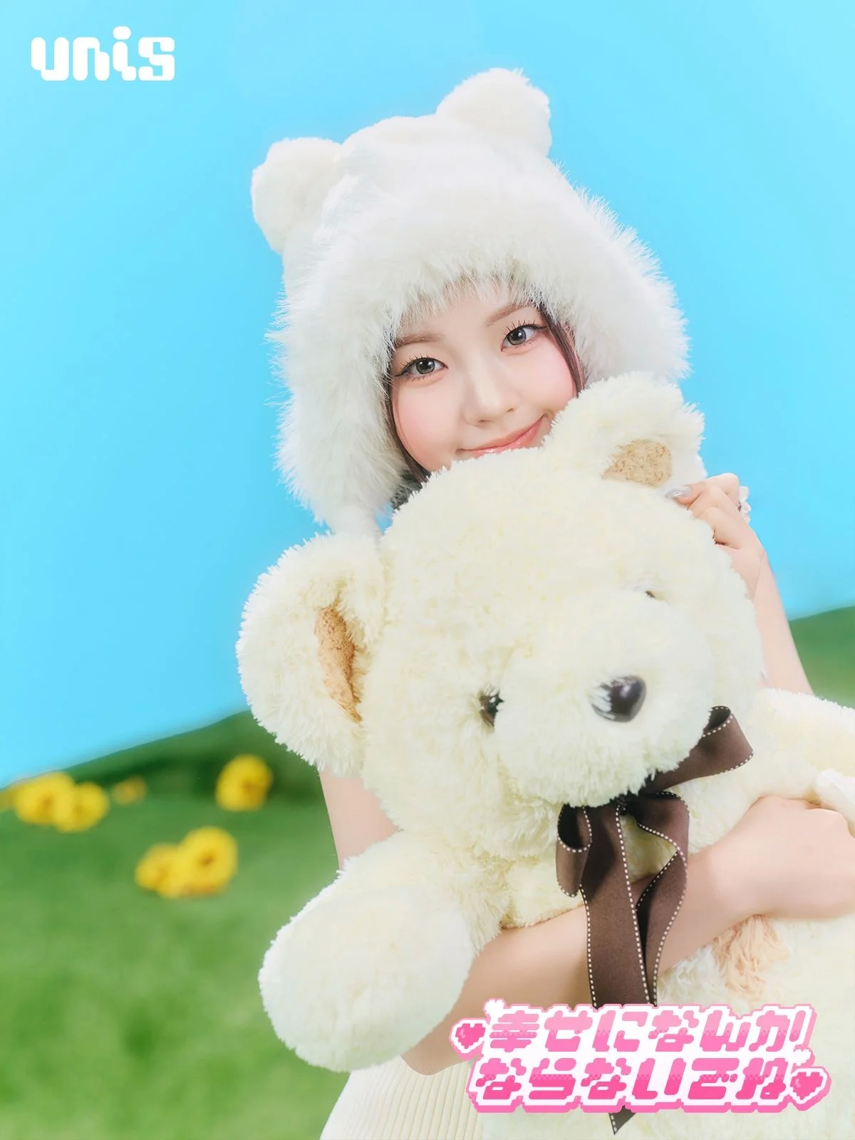 Person wearing a white bear hat hugging a teddy bear against a blue and green background
