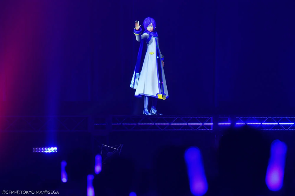 Digitaalinen hologrammi hahmosta KAITO esiintymässä lavalla sinisessä valaistuksessa.