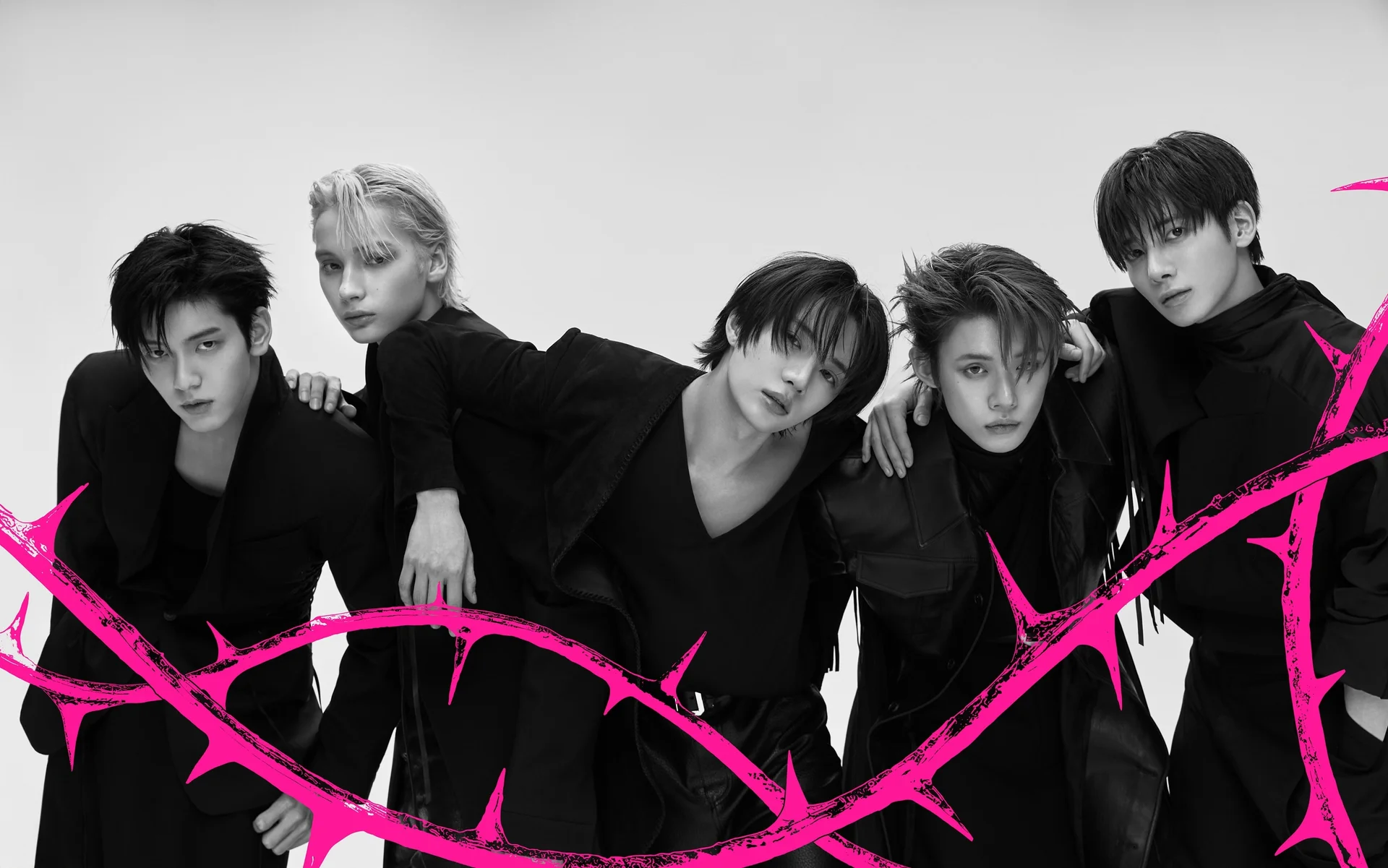 TXT members in black outfits with pink barbed wire graphics