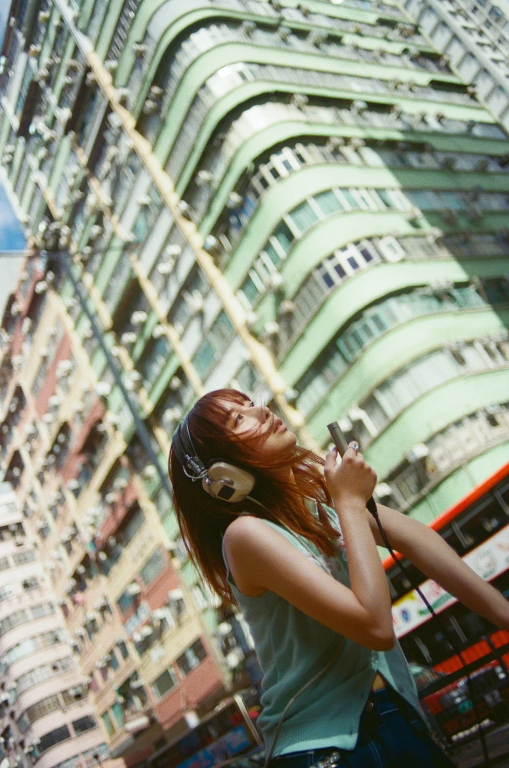 adieu smiling in front of a modern building