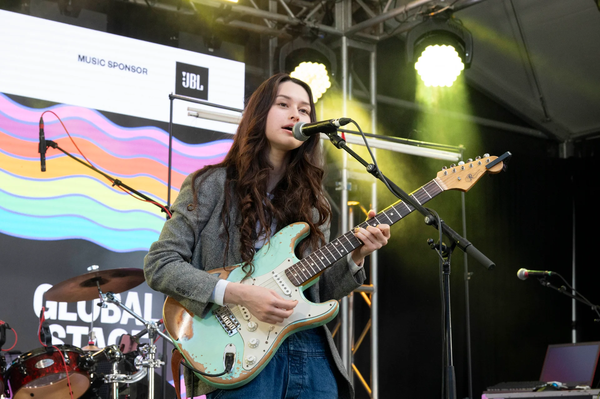 Muzyk występujący na scenie festiwalowej z gitarą