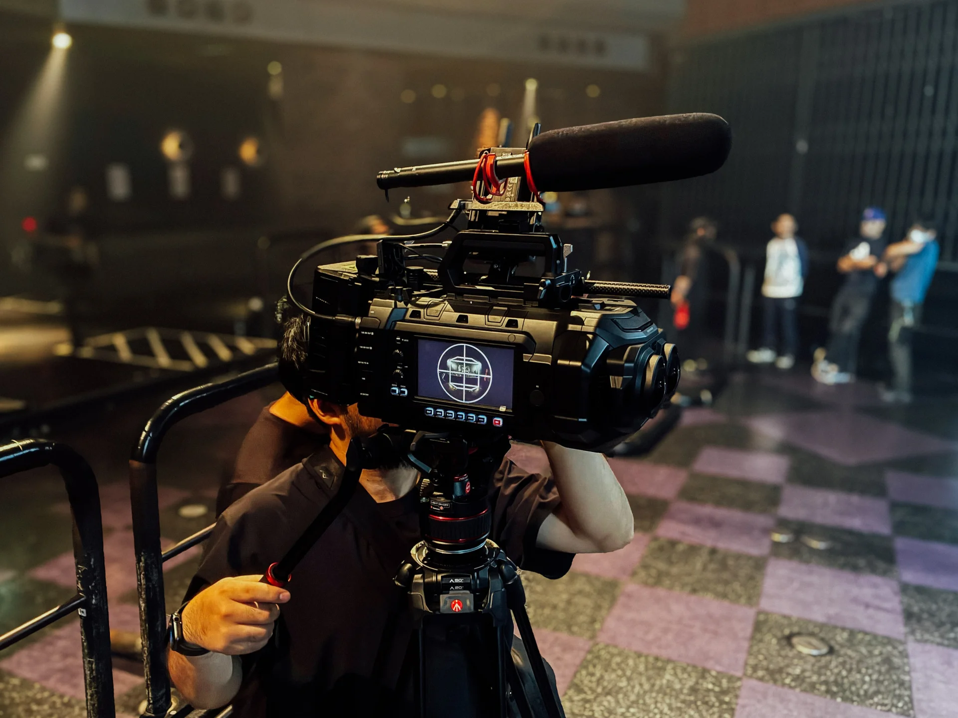 Camera operator filming in a concert venue
