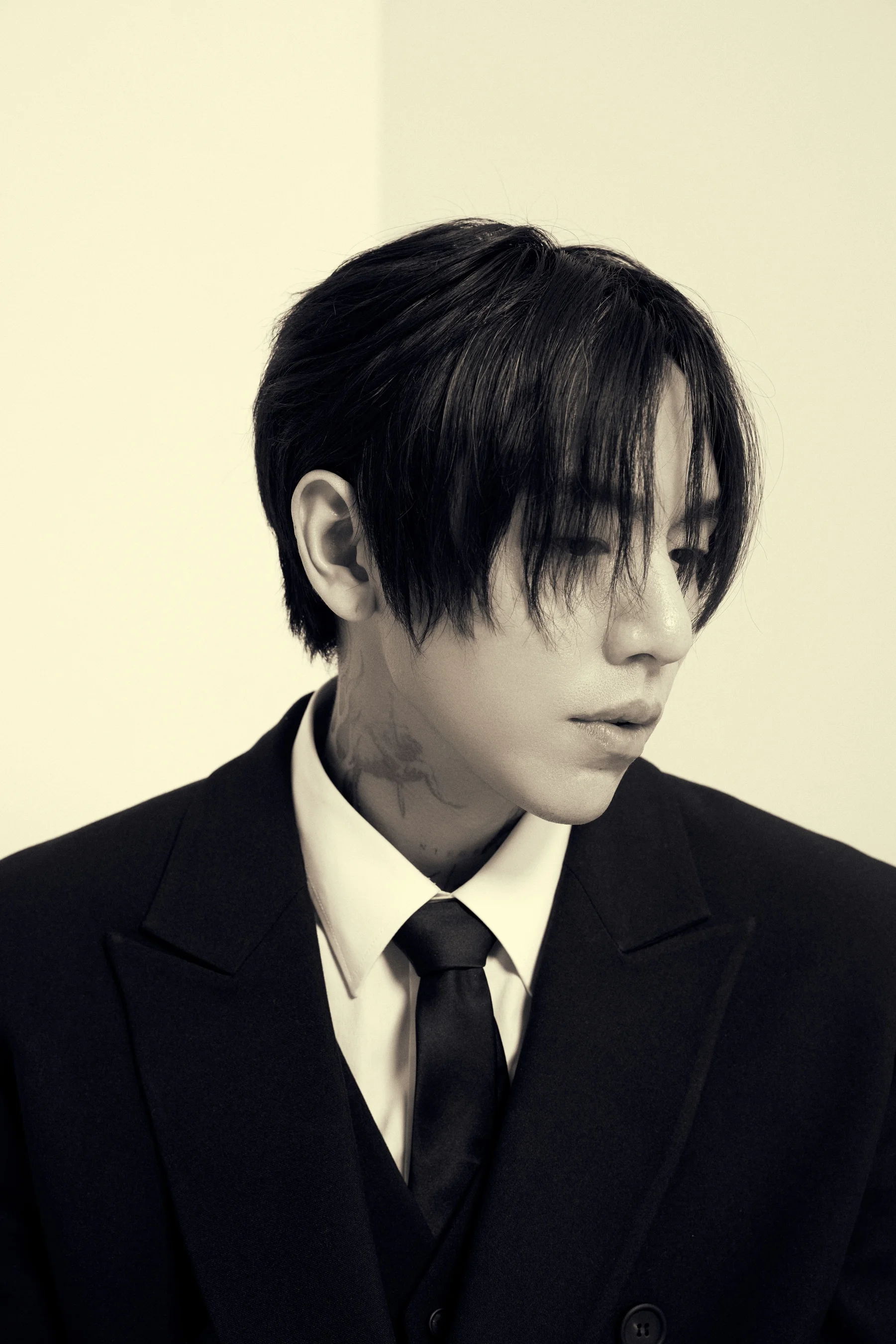 Fekete-fehér portré <a href="https://onlyhit.us/music/artist/DPR%20IAN" target="_blank">DPR IAN</a> öltönyben