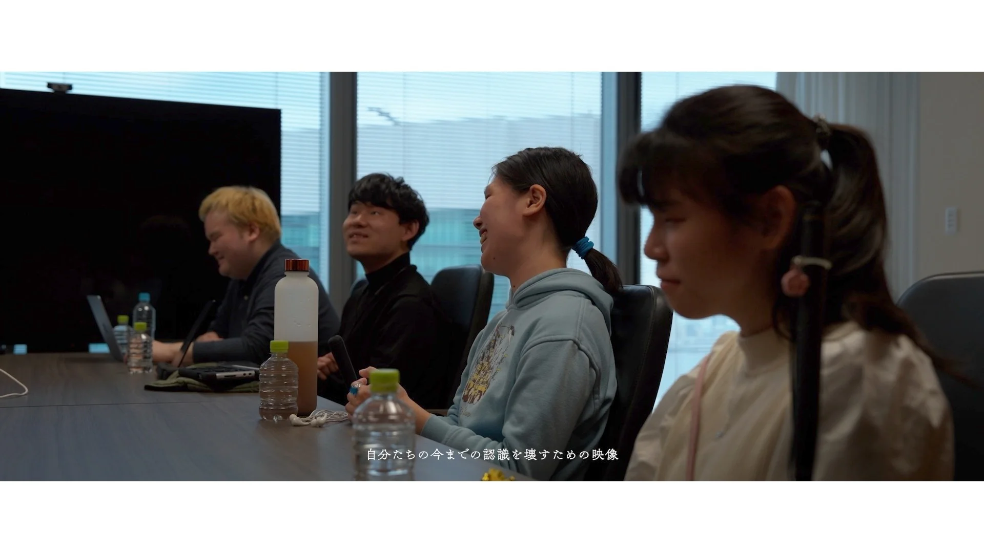 Four project participants sitting at a table in discussion