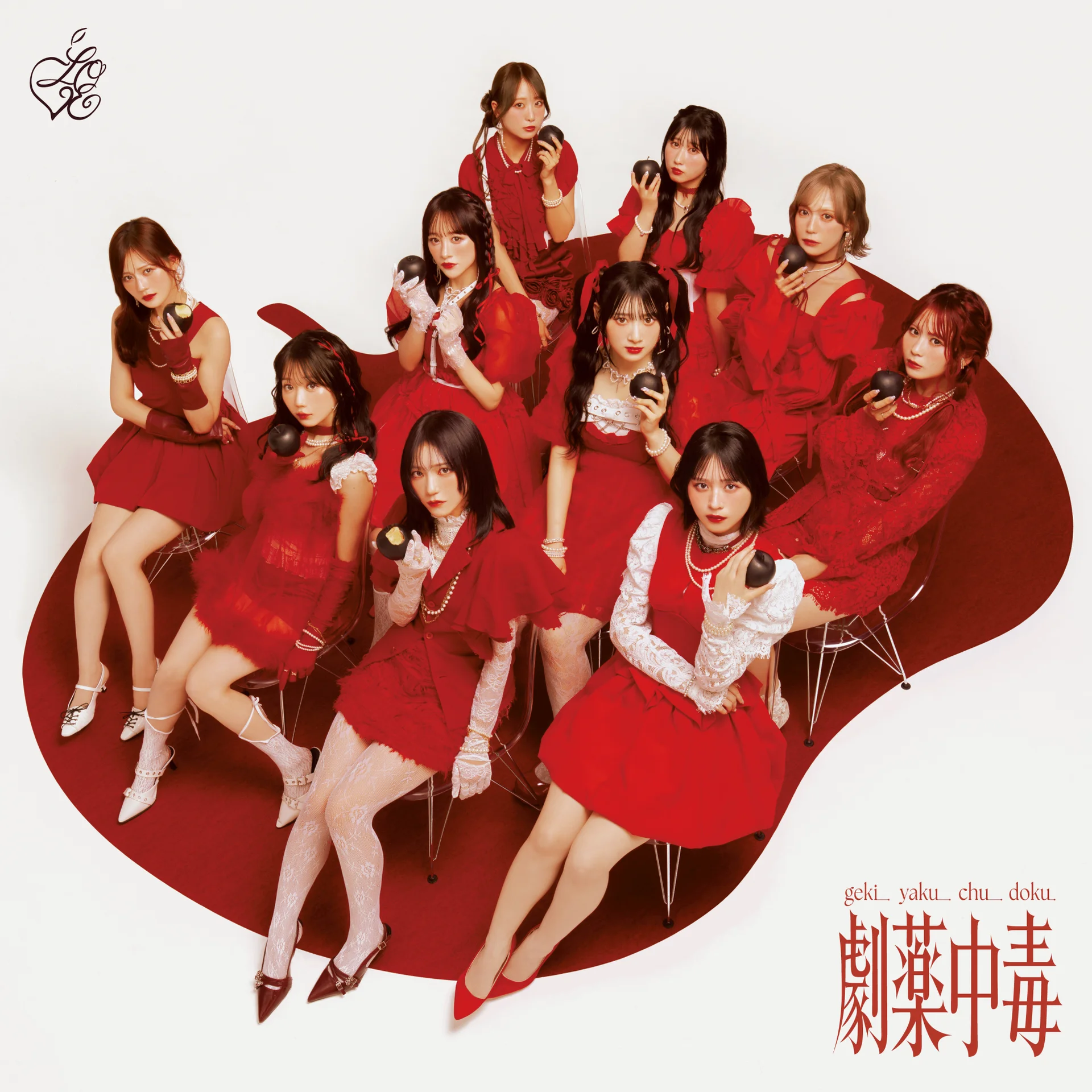 =LOVE members in red outfits seated on chairs