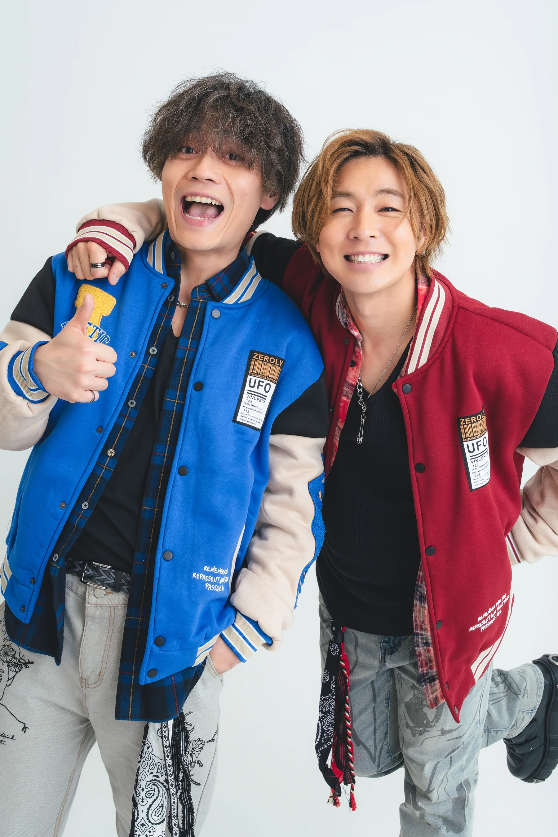 Ryu and Yuto Adachi posing in colorful varsity jackets