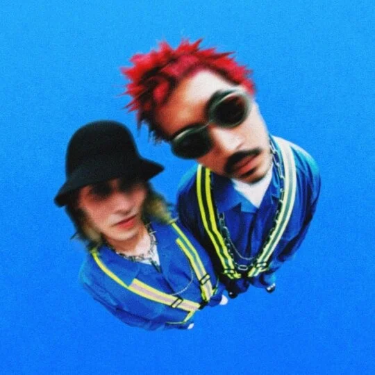 HUGEN members TP and another in blue outfits