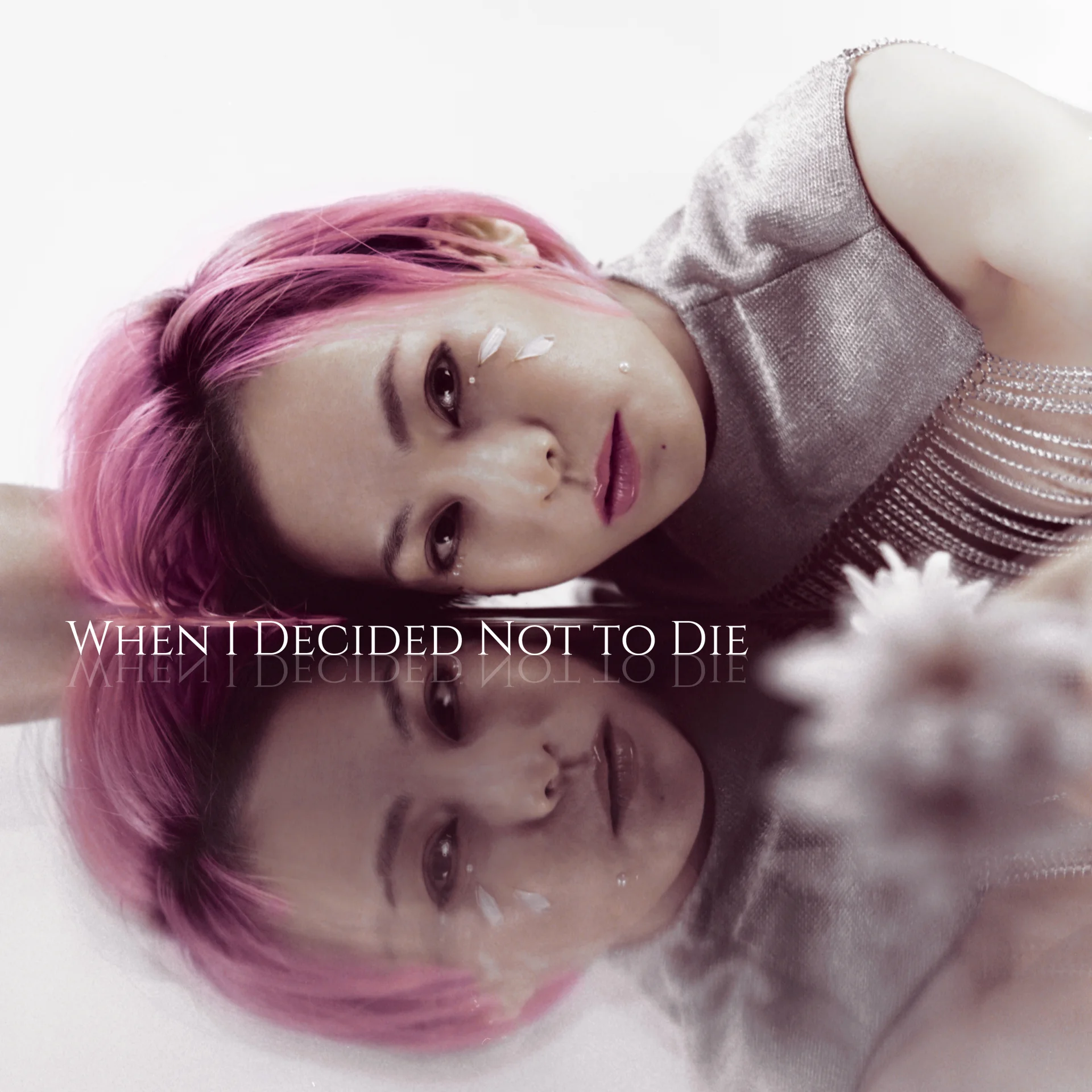 Shihori with pink hair lying on a reflective surface