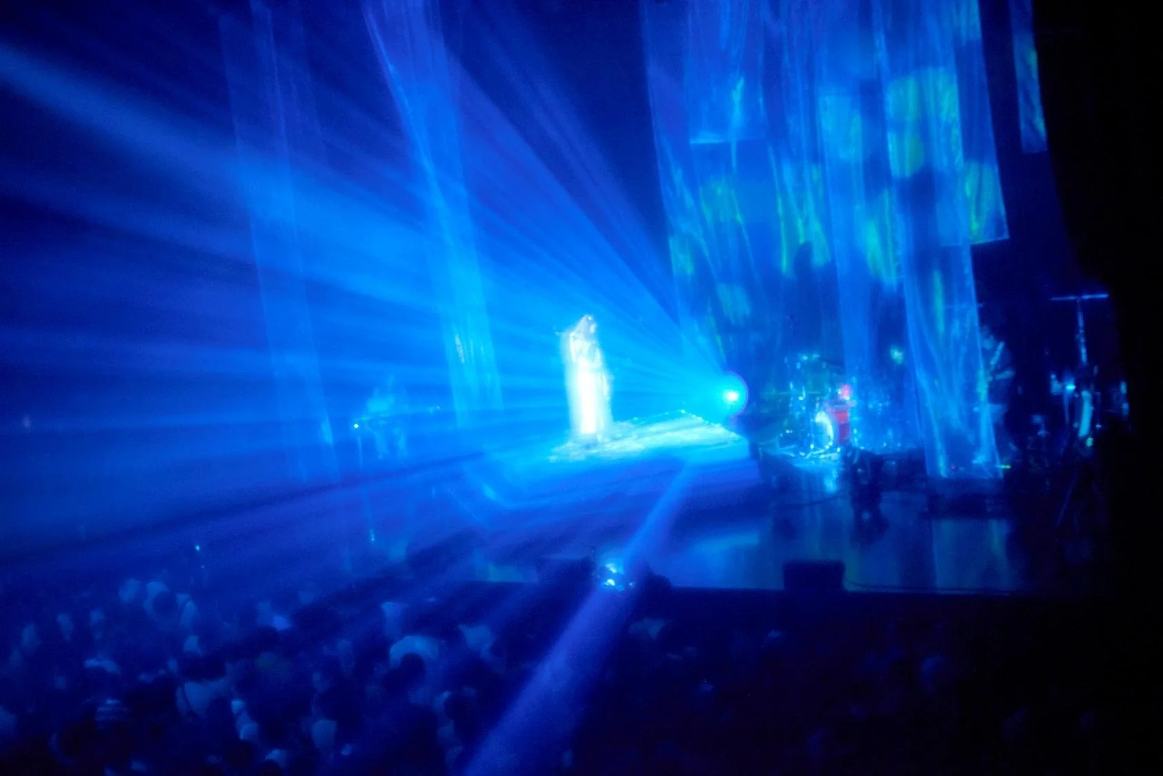 adieu performing on stage under blue lights