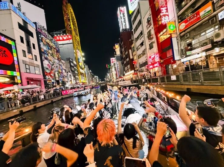Crowd gathered near a canal in Osaka at night