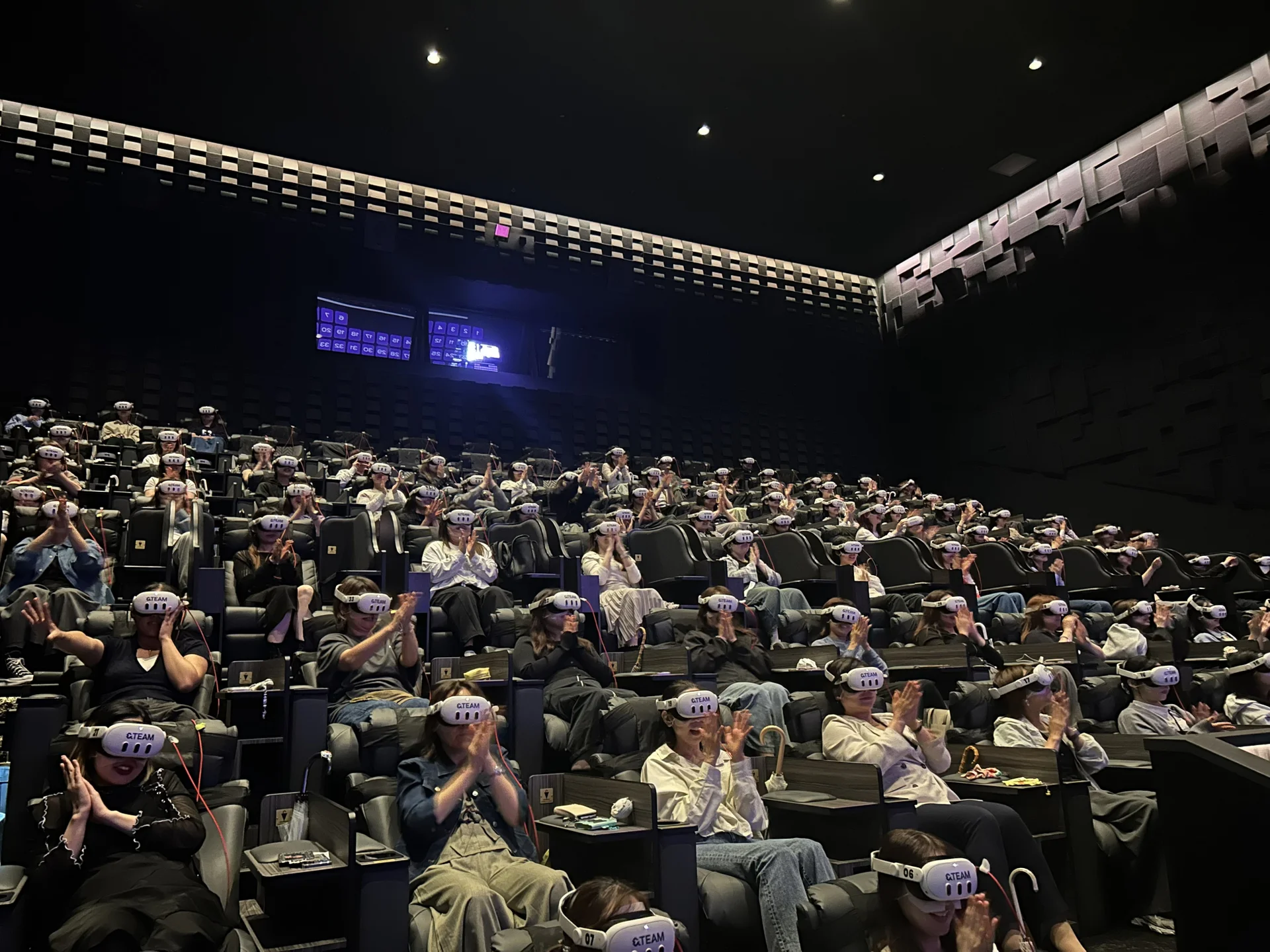 Audience in a theater wearing VR headsets