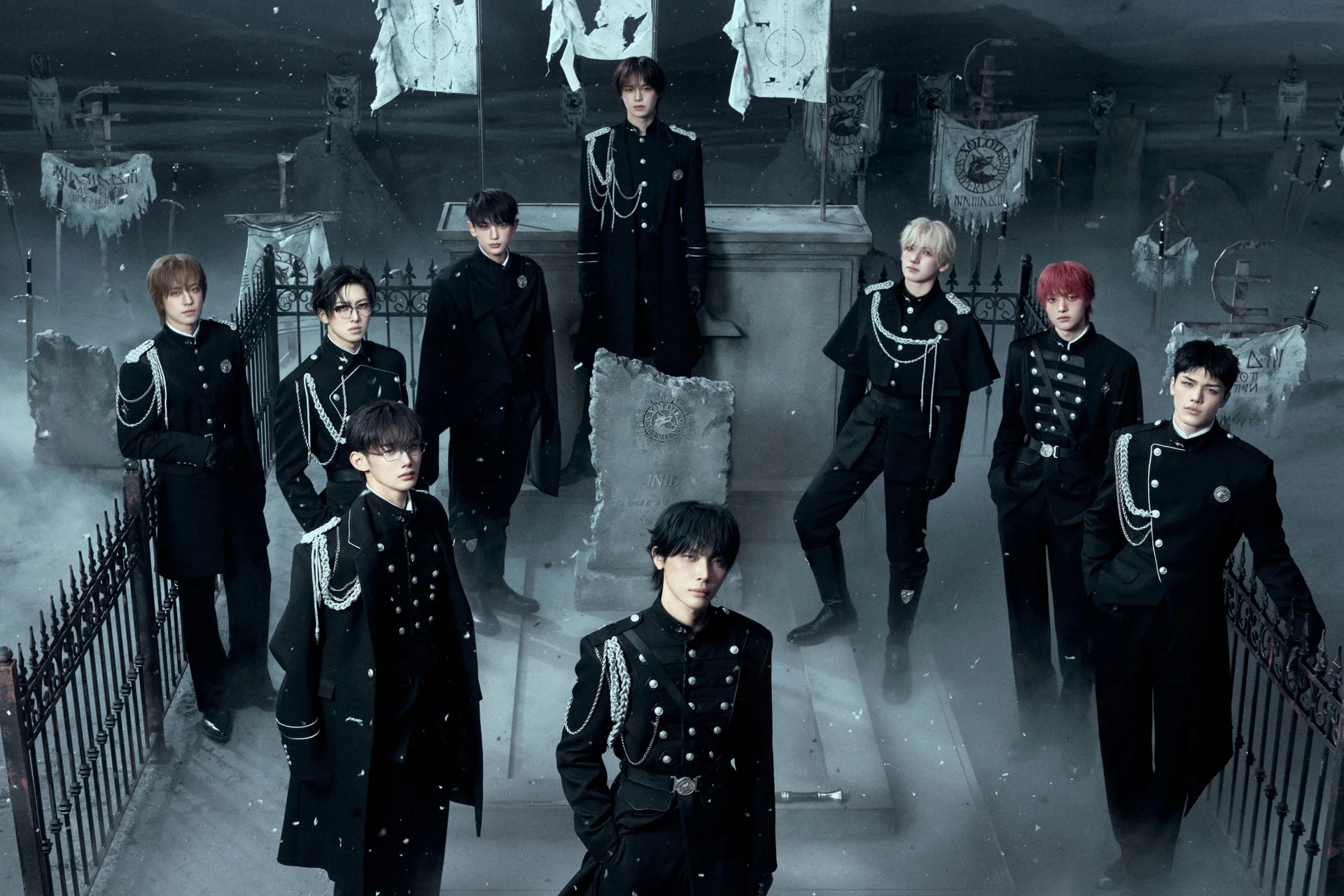 &TEAM in black military-style outfits in a misty setting