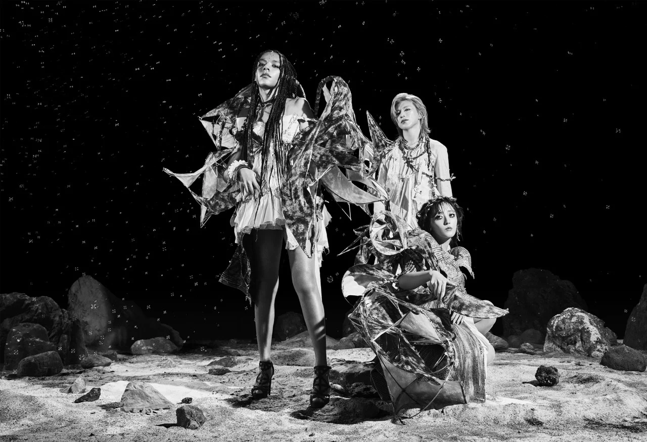 Queen Bee band members in avant-garde outfits