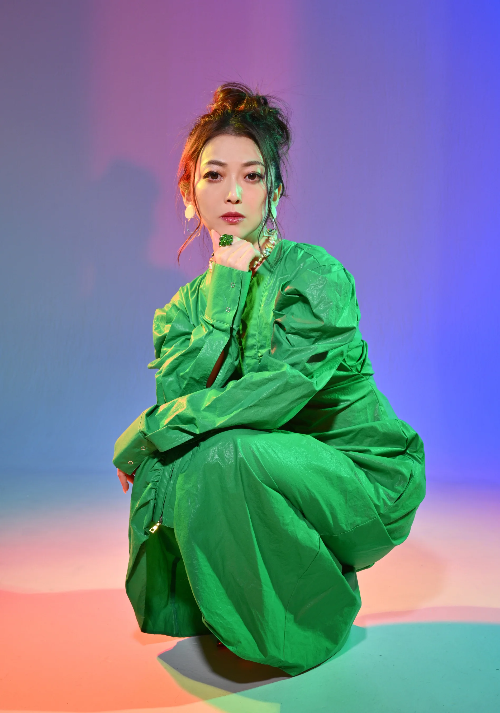 Lia posing in a bright green outfit