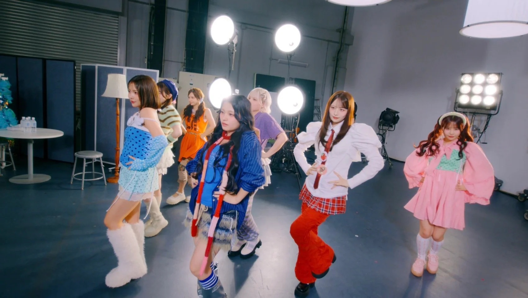 CANDY TUNE members in colorful outfits posing in a studio