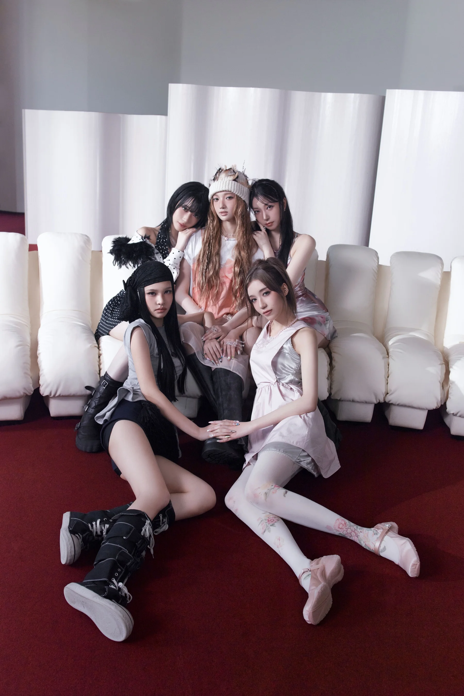 A2O MAY members on a white couch