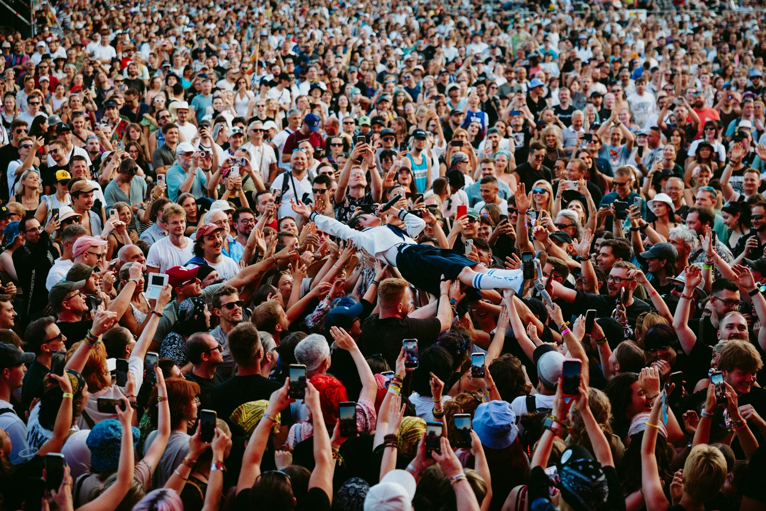 Crowd surfing at a large outdoor music festival