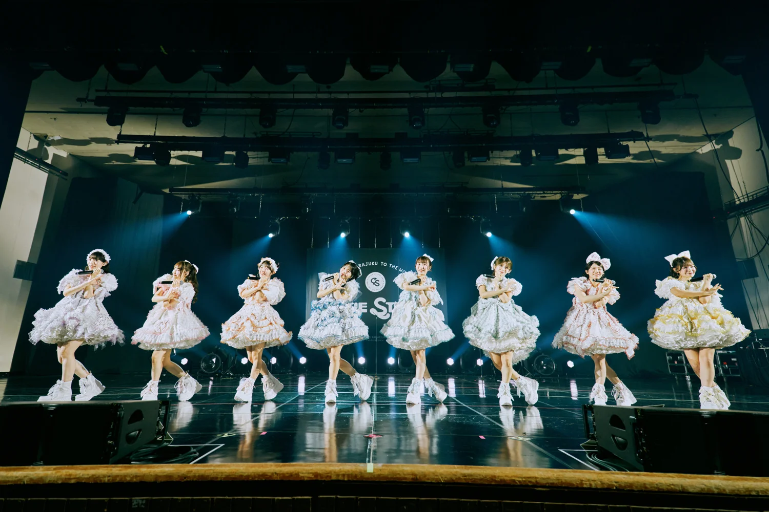 CUTIE STREET members on stage in frilly outfits