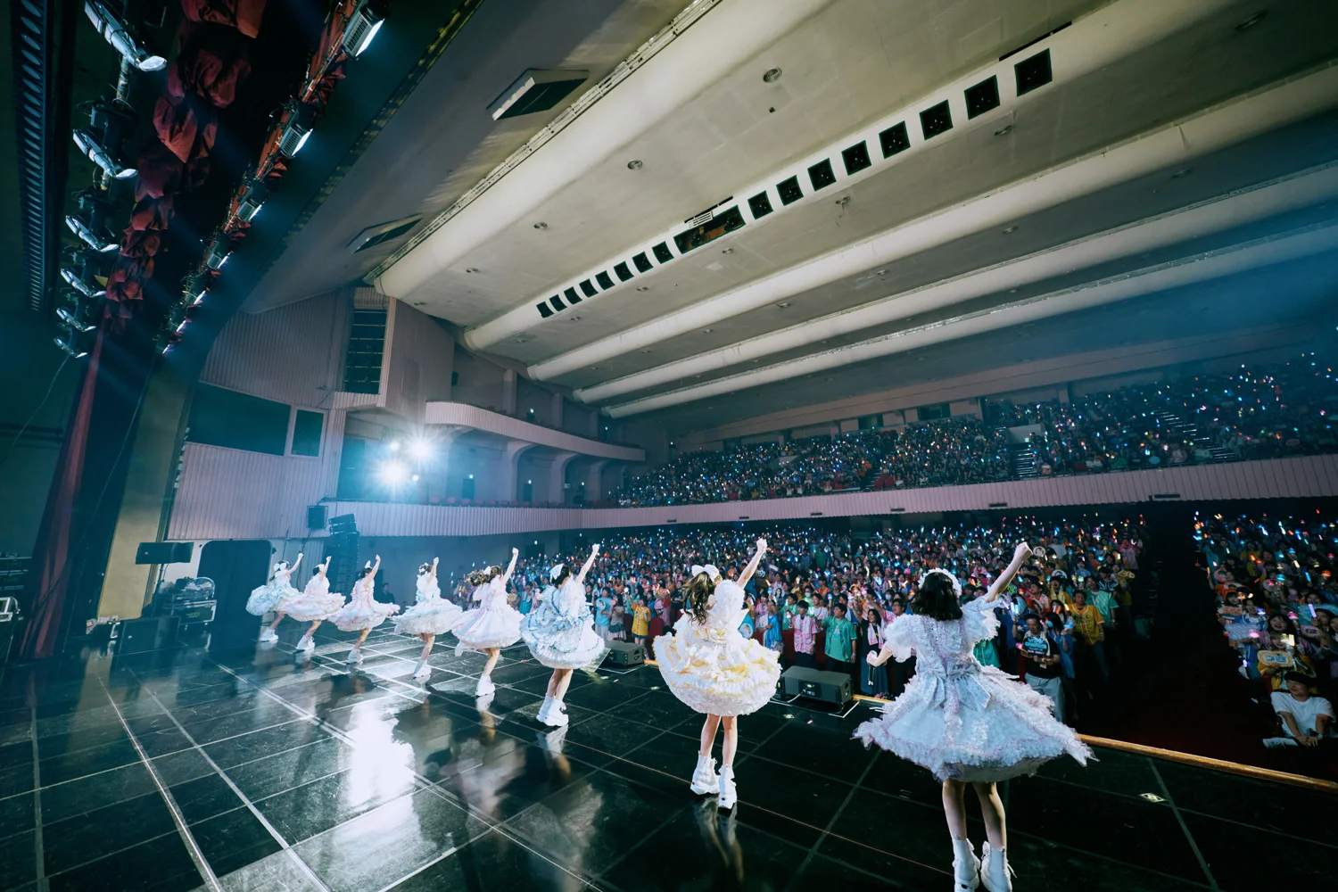CUTIE STREET performing in front of an audience holding light sticks