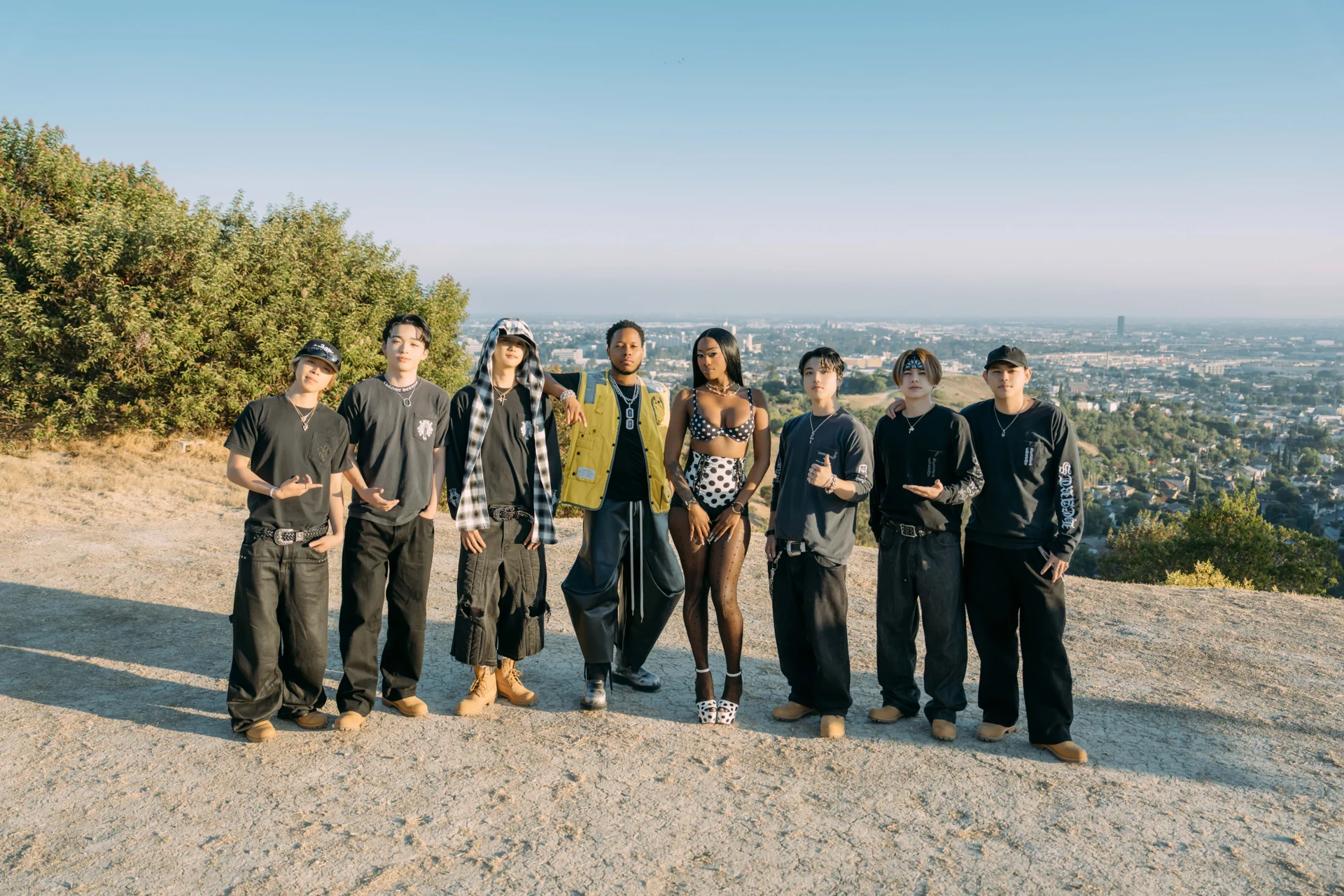 BE:FIRST with collaborators in a group photo outdoors
