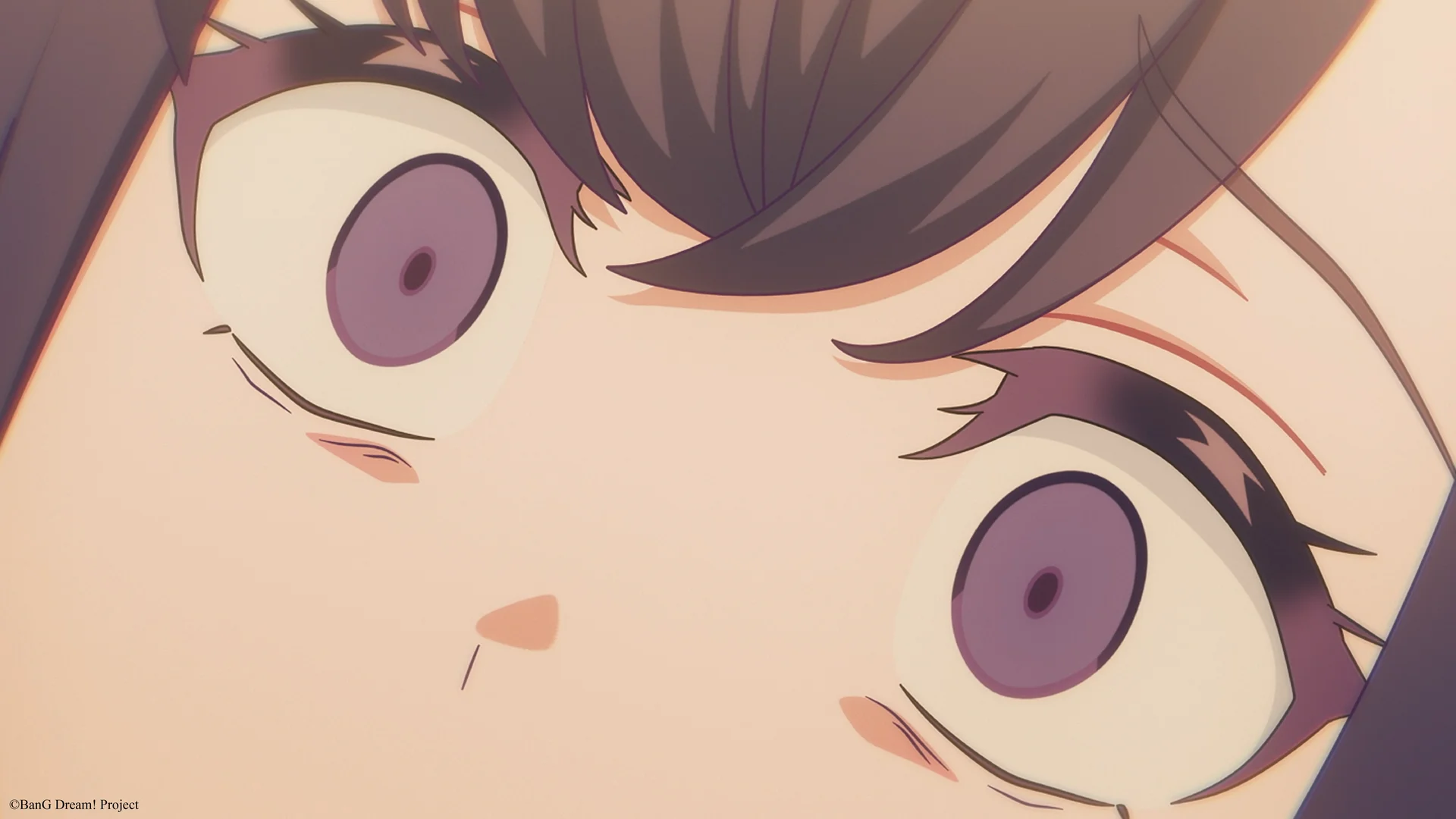 Close-up of an anime character with wide purple eyes