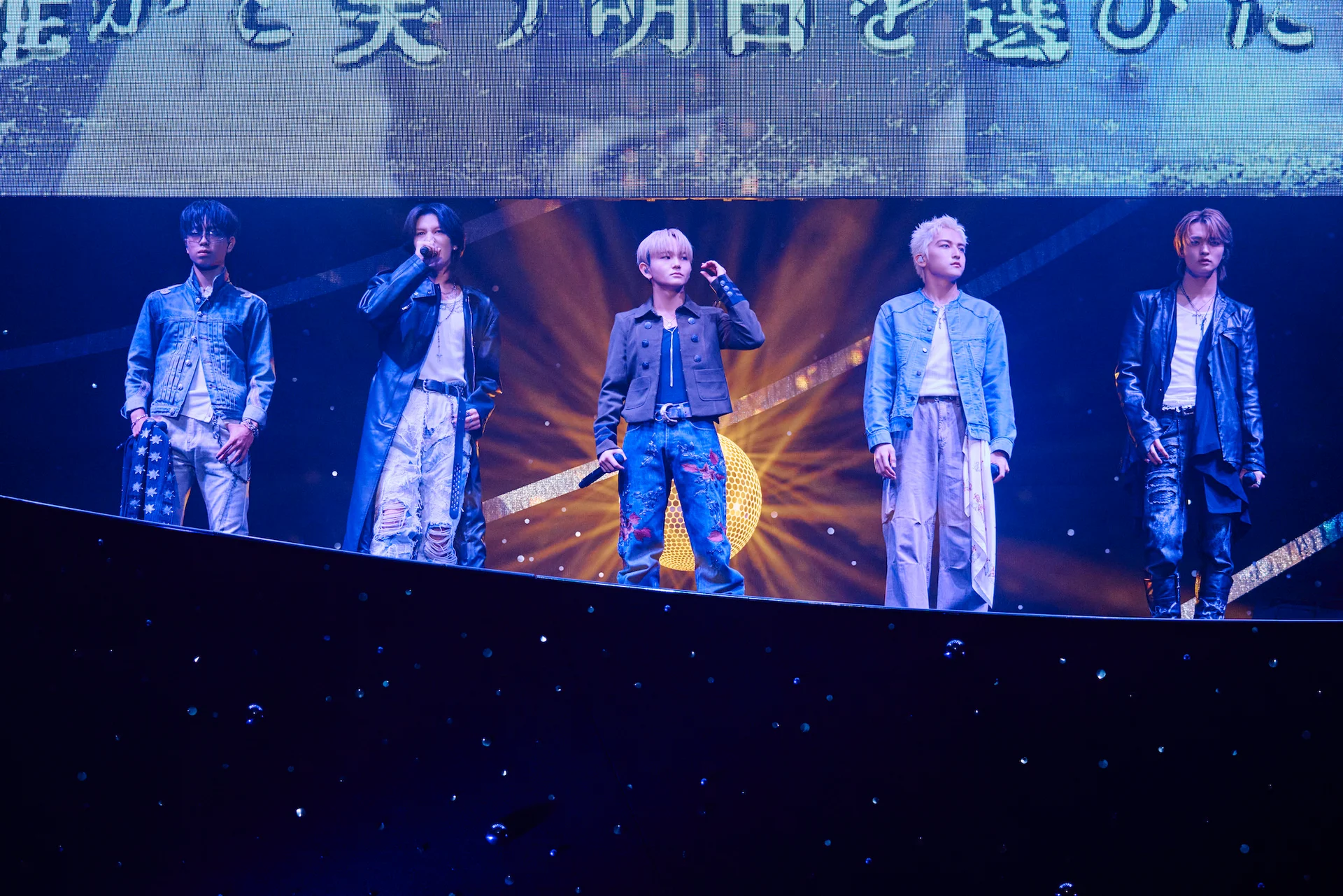 STARGLOW performing on stage with cosmic backdrop