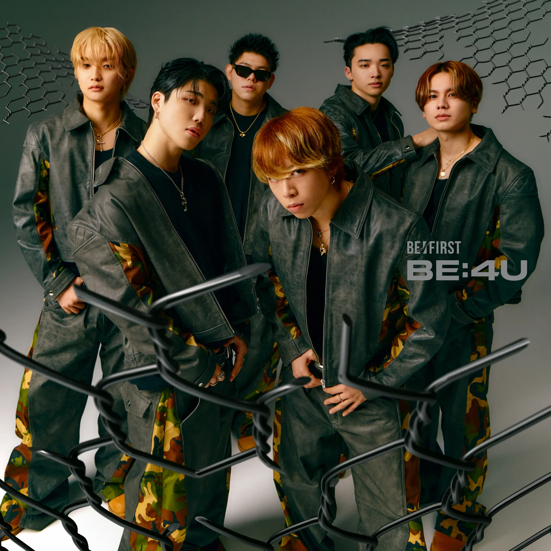 BE:FIRST members posing behind barbed wire