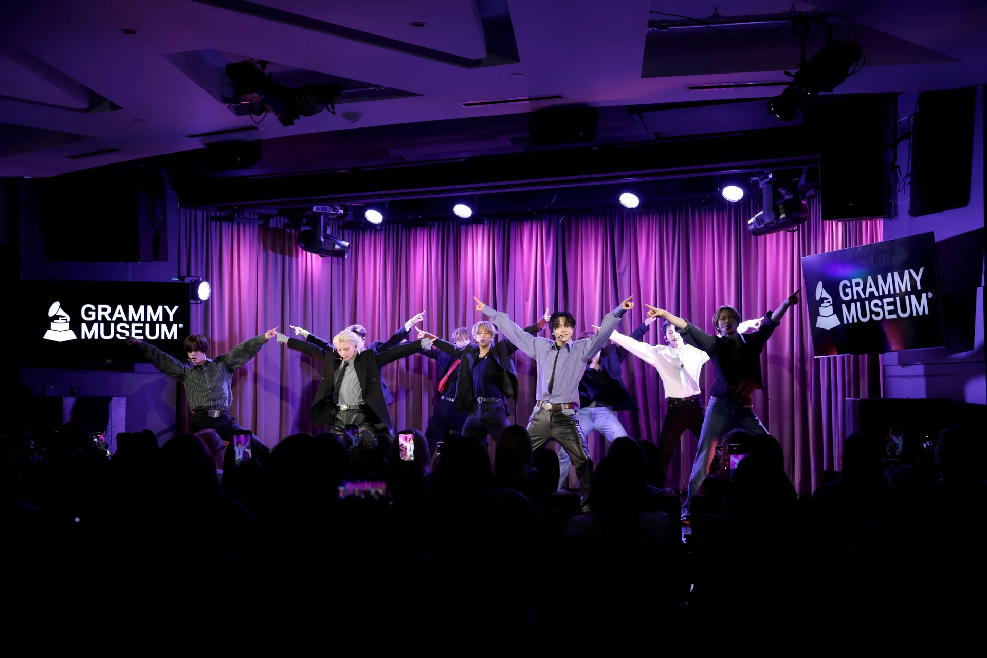 &TEAM performing under purple lights at the Grammy Museum
