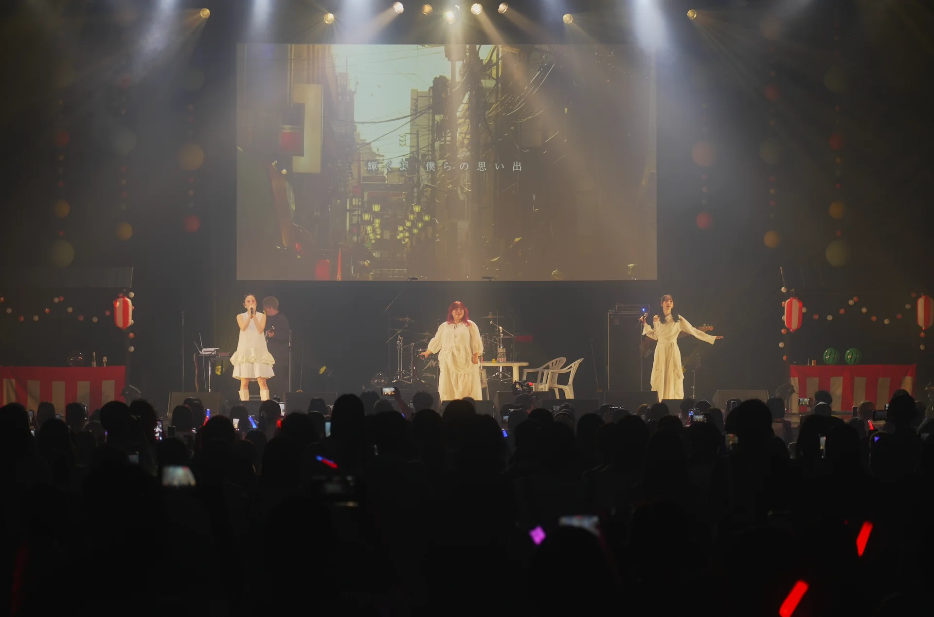 Kuremag_ performing on stage under colorful lights
