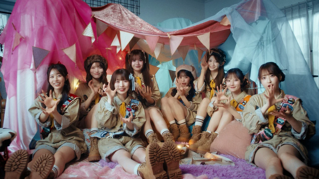 CUTIE STREET members in scout uniforms under a tent